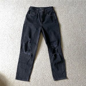 Black high waist denim with distressed rips at knees